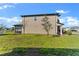 Expansive backyard with tropical foliage, featuring a screened-in lanai to maximize the outdoor experience at 34244 Radley Way, Wesley Chapel, FL 33545