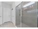 Elegant bathroom showcases a glass shower with a tiled surround and built-in shelves for toiletries at 34244 Radley Way, Wesley Chapel, FL 33545