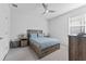 Comfortable bedroom with wooden bed frame, ceiling fan, and window providing natural light at 34244 Radley Way, Wesley Chapel, FL 33545