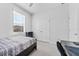 Simple bedroom with a twin bed, small shelving unit, and closet at 34244 Radley Way, Wesley Chapel, FL 33545