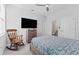 Bedroom featuring a comfortable bed with a wooden rocking chair and TV at 34244 Radley Way, Wesley Chapel, FL 33545
