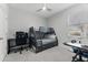 Neutral bedroom design with a bunk bed and desk area under a window at 34244 Radley Way, Wesley Chapel, FL 33545