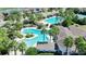 Aerial view of a stunning community pool area, complete with palm trees and lounge chairs at 34244 Radley Way, Wesley Chapel, FL 33545