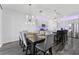 Bright dining area with stylish light fixture adjacent to kitchen with stainless steel appliances at 34244 Radley Way, Wesley Chapel, FL 33545