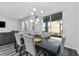 Dining area features stylish lighting and a sliding glass door to the outdoors at 34244 Radley Way, Wesley Chapel, FL 33545