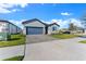 Well-manicured lawn and landscaping highlight this single-Gathering home with a two car garage at 34244 Radley Way, Wesley Chapel, FL 33545