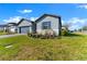 Well-manicured lawn and landscaping highlight this single-Gathering home with a two car garage at 34244 Radley Way, Wesley Chapel, FL 33545