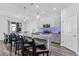 Modern kitchen features gray cabinets, granite counters, stainless appliances, and an island with bar seating at 34244 Radley Way, Wesley Chapel, FL 33545