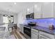 Kitchen featuring stainless steel appliances, granite countertops, and decorative lighting at 34244 Radley Way, Wesley Chapel, FL 33545