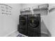 Laundry room with washer, dryer and storage, complete with Laundry Room sign at 34244 Radley Way, Wesley Chapel, FL 33545