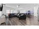 Open concept living area showcases sleek flooring, modern furnishings, and stylish decor at 34244 Radley Way, Wesley Chapel, FL 33545