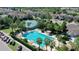 An aerial view of a refreshing community pool, palm trees, and cabanas for relaxation at 34244 Radley Way, Wesley Chapel, FL 33545