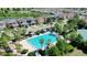 Aerial view of the pool and surrounding neighborhood showcasing palm trees and cabanas for relaxation at 34244 Radley Way, Wesley Chapel, FL 33545
