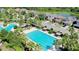Aerial view of a large, rectangular community pool featuring several swim lanes and tropical landscaping at 34244 Radley Way, Wesley Chapel, FL 33545