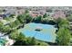 Aerial view of two well-maintained tennis courts, with mature trees and landscaping at 34244 Radley Way, Wesley Chapel, FL 33545