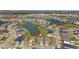 An aerial view of a house with surrounding neighborhood, marked with a pin for location, near a beautiful pond at 34311 Evergreen Hill Ct, Wesley Chapel, FL 33545