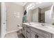 Well-lit bathroom features double sinks, granite countertops, gray cabinets, and tiled floor at 34311 Evergreen Hill Ct, Wesley Chapel, FL 33545