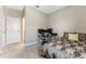 Bedroom featuring neutral walls, comfortable bed, and a functional desk area by the entry door at 34311 Evergreen Hill Ct, Wesley Chapel, FL 33545
