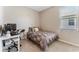 Cozy bedroom featuring neutral walls, a comfortable bed, and a functional desk area by the window at 34311 Evergreen Hill Ct, Wesley Chapel, FL 33545
