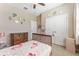 Inviting bedroom with pink flamingo bedding, a ceiling fan, and double door closet at 34311 Evergreen Hill Ct, Wesley Chapel, FL 33545