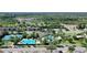 Overhead shot of a community pool area, a clubhouse, and tennis courts surrounded by lush landscaping at 34311 Evergreen Hill Ct, Wesley Chapel, FL 33545