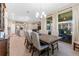 Dining area with large wood table, comfortable seating, and natural light from sliding glass doors to a covered patio at 34311 Evergreen Hill Ct, Wesley Chapel, FL 33545