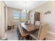 Charming dining room with a large wood table, comfortable chairs, and natural light streaming through the windows at 34311 Evergreen Hill Ct, Wesley Chapel, FL 33545