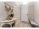 Inviting entryway features neutral walls, modern decor, and stylish console table with decorative accents and a small bench at 34311 Evergreen Hill Ct, Wesley Chapel, FL 33545