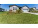 Landscaped front yard with lush green grass, stone accents, and a well-maintained lawn at 34311 Evergreen Hill Ct, Wesley Chapel, FL 33545