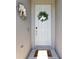 Charming front door with a decorative wreath, a stylish doormat, and a modern lock system at 34311 Evergreen Hill Ct, Wesley Chapel, FL 33545