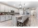 Gourmet kitchen with granite countertops, modern pendant lighting, stainless steel appliances, and eat-in island with seating at 34311 Evergreen Hill Ct, Wesley Chapel, FL 33545