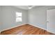 Cozy bedroom with wood floors, a ceiling fan, and natural light from a window at 3615 16Th N St, St Petersburg, FL 33704