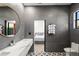 Beautiful bathroom featuring grey tiling, a white marble countertop, and a modern, geometric tiled floor at 3635 80Th E Dr, Sarasota, FL 34243
