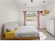 Cozy bedroom featuring a large arched window, natural light, and neutral decor at 3635 80Th E Dr, Sarasota, FL 34243