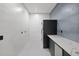 Sleek laundry room with modern washer and dryer, countertop, and ample storage space at 3635 80Th E Dr, Sarasota, FL 34243