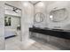 Ensuite bathroom with double sinks, sleek countertops, and a glass shower at 3635 80Th E Dr, Sarasota, FL 34243