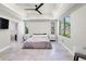 Airy main bedroom features a trey ceiling, ensuite bath, and windows at 3635 80Th E Dr, Sarasota, FL 34243