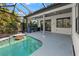 Inviting pool area with outdoor kitchen and screened enclosure at 3635 80Th E Dr, Sarasota, FL 34243