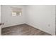 A bright bedroom with neutral wall paint, a window, and laminate flooring at 3684 14Th Se Ave, Largo, FL 33771