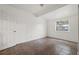 A bright bedroom featuring neutral wall paint, a window, and tile flooring at 3684 14Th Se Ave, Largo, FL 33771