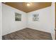 A bright bedroom featuring neutral wall paint, two windows, and laminate flooring at 3684 14Th Se Ave, Largo, FL 33771