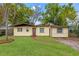 Charming single-story home with a well-maintained lawn and brick pathway leading to the front door at 3684 14Th Se Ave, Largo, FL 33771