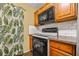 Updated kitchen with modern appliances, wooden cabinets, and stylish subway tile backsplash at 3684 14Th Se Ave, Largo, FL 33771