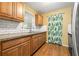 Bright kitchen featuring wood floors, granite counters, and stainless steel sink at 3684 14Th Se Ave, Largo, FL 33771
