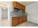 Functional kitchen with granite counters, wood cabinets, and tiled backsplash, ready for meals at 3684 14Th Se Ave, Largo, FL 33771