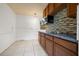 Efficient kitchen features granite counters, stainless microwave, and tiled backsplash at 3684 14Th Se Ave, Largo, FL 33771