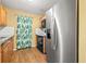 Kitchen with wooden cabinets, stainless steel refrigerator and modern appliances at 3684 14Th Se Ave, Largo, FL 33771