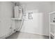 Clean utility room with water heater and updated electrical panel at 3684 14Th Se Ave, Largo, FL 33771