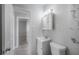 Clean bathroom featuring a mirrored cabinet, sink, toilet, and view of the shower at 3714 38Th N Ave, St Petersburg, FL 33713