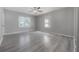 An airy bedroom with two windows and new gray flooring under a ceiling fan at 3714 38Th N Ave, St Petersburg, FL 33713